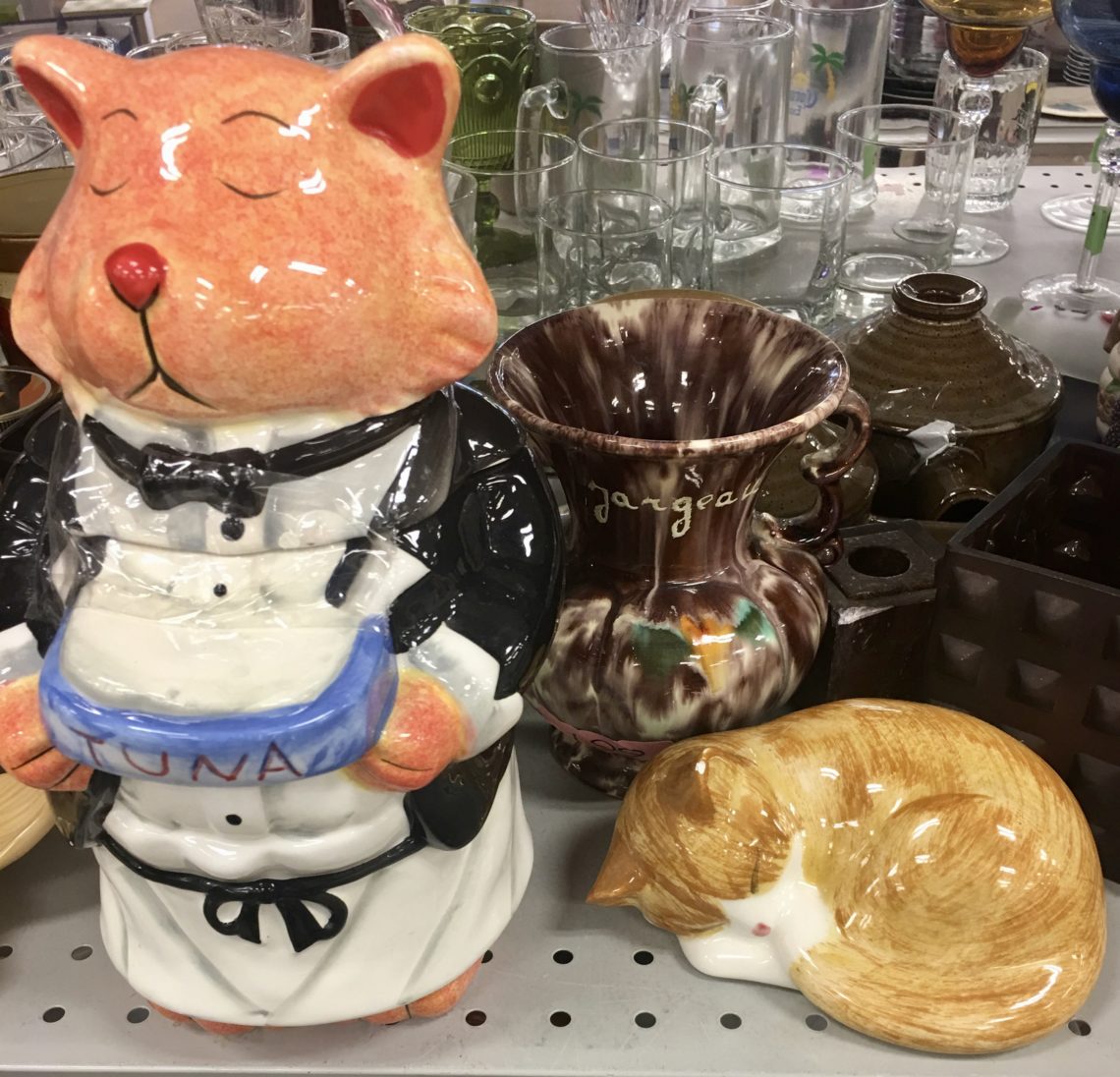 A cat-themed cookie jar and statue