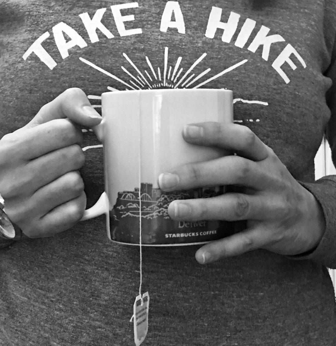 A woman holds a mug of hot tea